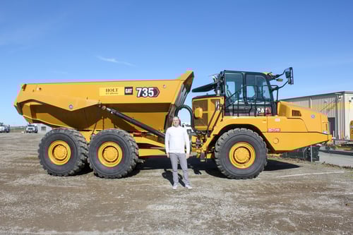 Andrew Distler in front of CAT dump truck