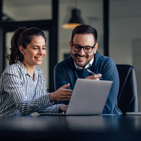 Portrait of two business colleagues, looking at something online