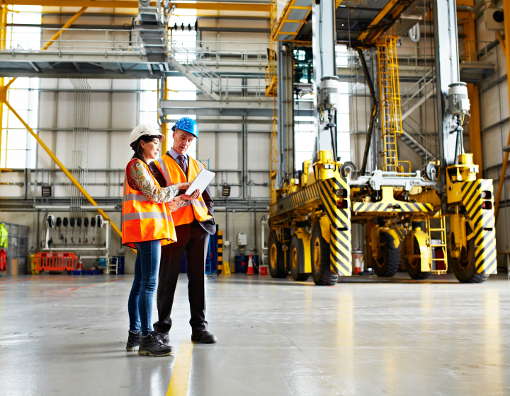 people-reviewing-information-at-heavy-equipment-dealership