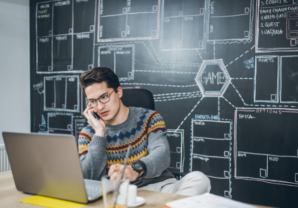 Man-working-in-office-with-charts-in-the-background-data-integration