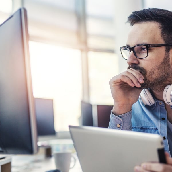 Man looking at data overview on computer
