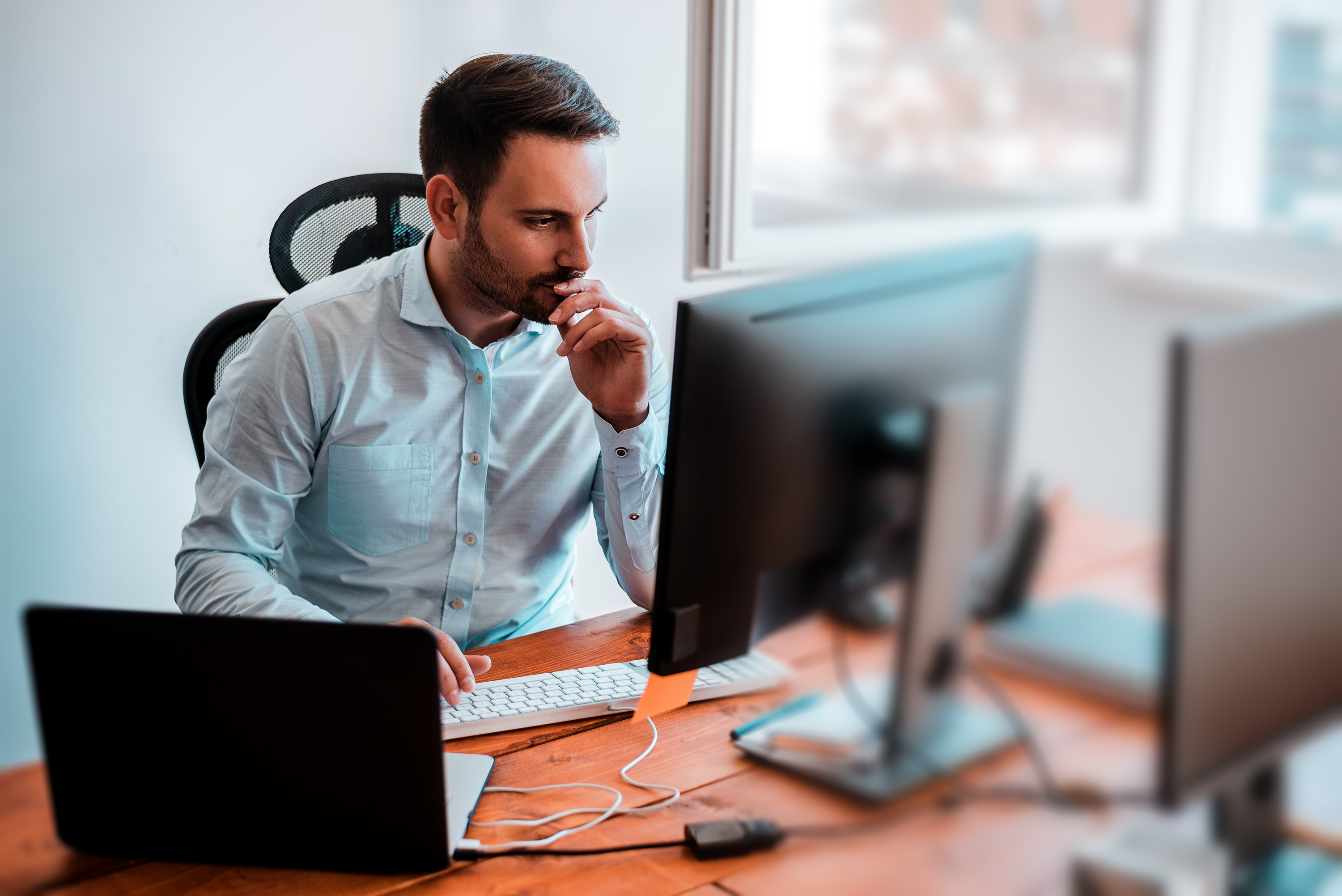 man-thinking-looking-in-to-computer