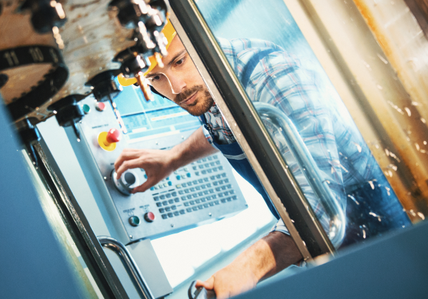 man-fixing-manufacturing-machine-looking-down