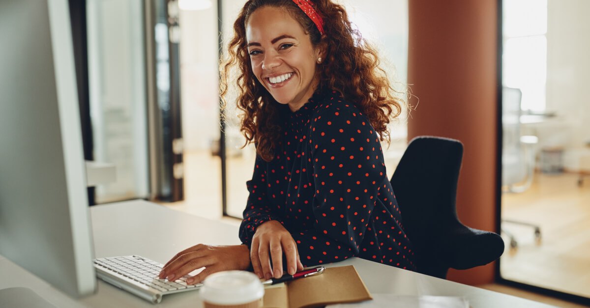 woman at desktop smiling-1